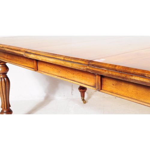 1044 - A Victorian revival mahogany wind out dining table. The table raised on shaped gadrooned supports ov... 