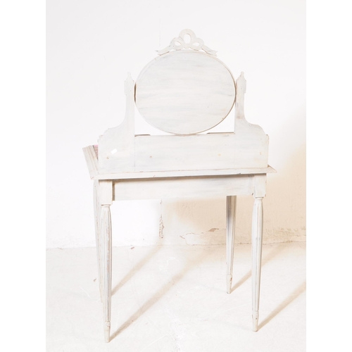 1045 - A Louis XVI style marble topped mirror back dressing table. The dressing table raised on tapered flu... 