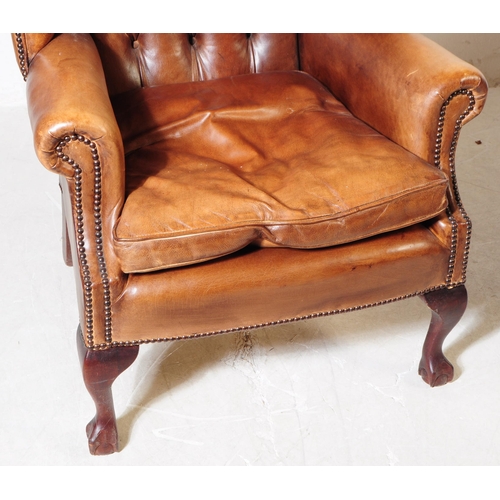 1052 - Chesterfield style - A 20th Century tan brown leather Chesterfield manner wingback armchair. Raised ... 