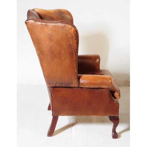 1052 - Chesterfield style - A 20th Century tan brown leather Chesterfield manner wingback armchair. Raised ... 