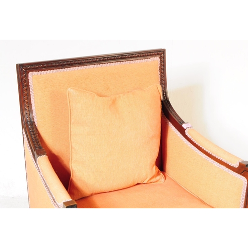 1055 - A pair of 20th century bergere French armchairs. The chairs having mahogany frames with moulded deta... 