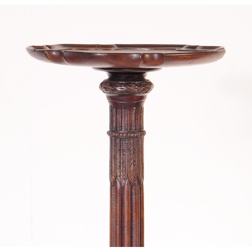 1056 - A 19th Century Victorian mahogany torchere / plant stand. Having circular platform to top and reeded... 