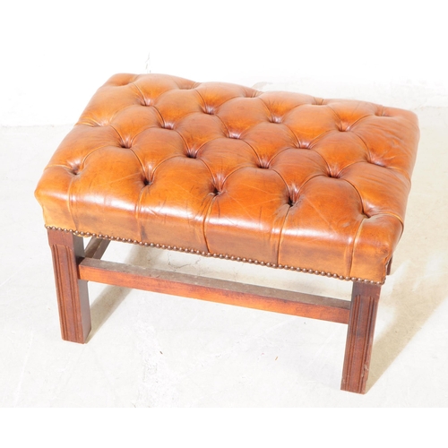 1069 - A 20th century circa 1940s Chesterfield style leather footstool. The footstool having tan tufted lea... 