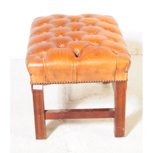 1069 - A 20th century circa 1940s Chesterfield style leather footstool. The footstool having tan tufted lea... 