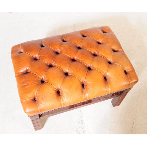 1069 - A 20th century circa 1940s Chesterfield style leather footstool. The footstool having tan tufted lea... 