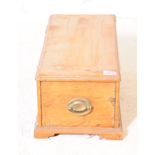 1074 - An 19th century pine wood small proportioned chest / coffer. The chest raised on block bracket feet,... 