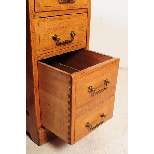 1075 - A 20th century oak twin pedestal desk. The desk having chamfered edge raised over twin pedestals, ea... 