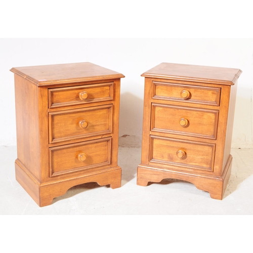 1077 - A pair of 20th century hardwood bedside pedestal chest of drawers. Each having chamfered top over a ... 