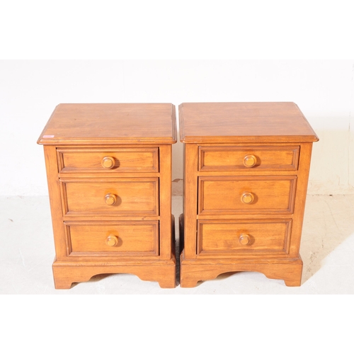 1077 - A pair of 20th century hardwood bedside pedestal chest of drawers. Each having chamfered top over a ... 