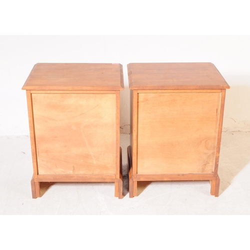 1077 - A pair of 20th century hardwood bedside pedestal chest of drawers. Each having chamfered top over a ... 