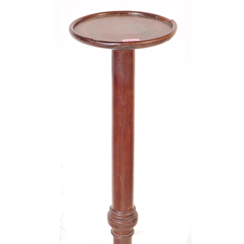 1078 - A 19th Century Victorian mahogany torchere / plant stand. Having circular table top upon rounded tur... 