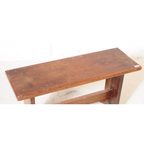 1079 - An early 20th century country oak wood bench stool. The stool having a rectangular top, raised on sq... 