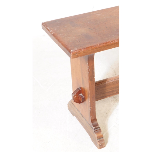 1079 - An early 20th century country oak wood bench stool. The stool having a rectangular top, raised on sq... 