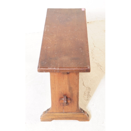 1079 - An early 20th century country oak wood bench stool. The stool having a rectangular top, raised on sq... 