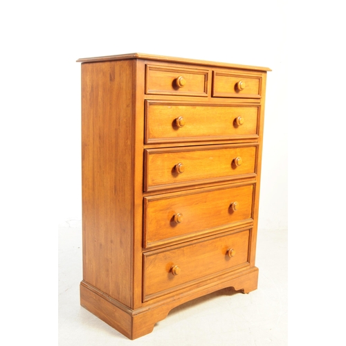 1081 - A 20th century hardwood dressing chest. The chest of drawers having mirror to top flanked by trinket... 