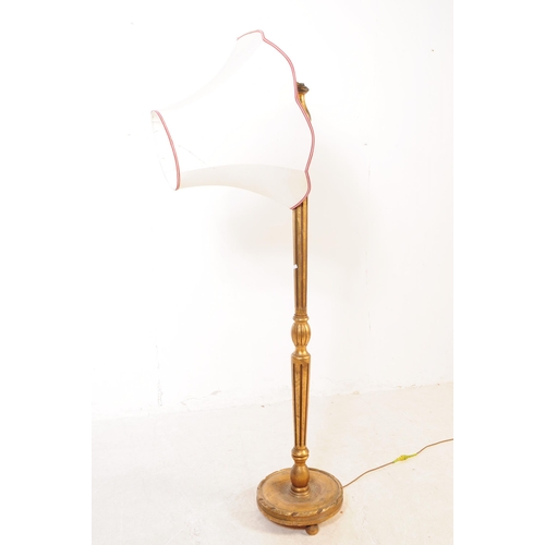 1085 - A 20th Century painted gilt wood reeded floor standing standard lamp. The lamp having raised on circ... 