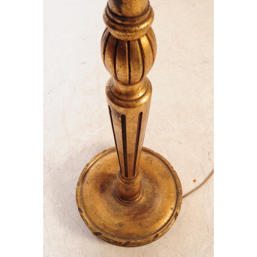 1085 - A 20th Century painted gilt wood reeded floor standing standard lamp. The lamp having raised on circ... 