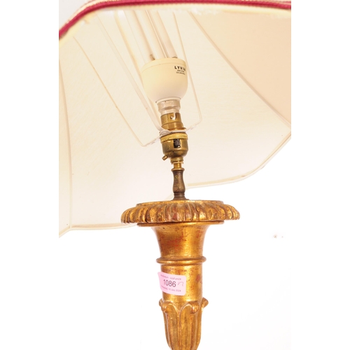 1086 - A 20th Century painted gilt wood floor standing standard lamp with lamp shade. The central column tu... 