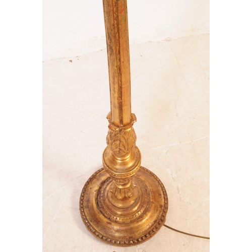 1086 - A 20th Century painted gilt wood floor standing standard lamp with lamp shade. The central column tu... 