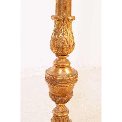 1086 - A 20th Century painted gilt wood floor standing standard lamp with lamp shade. The central column tu... 