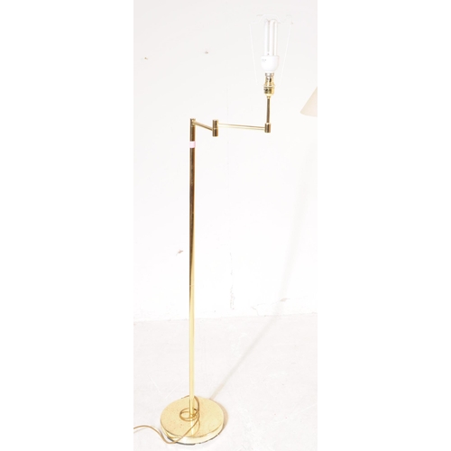 1087 - Two 20th century brass adjustable swing arm floor standing standard lamps. The lamps each raised on ... 