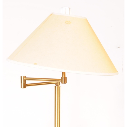 1089 - Two 20th century metal adjustable swing arm floor standing standard lamps. The lamps each raised on ... 