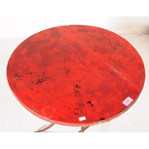 1096 - An early 20th century side table. The table having red lacquered circular top over metal tripod base... 