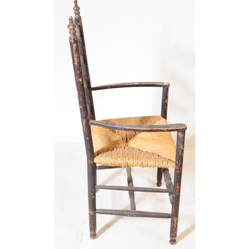 1104 - An 19th century Chinoiseries black lacquered Arts and Crafts carver chair having ladder back with ru... 