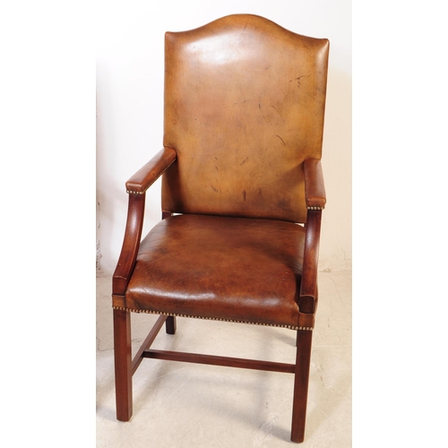 1106 - A pair of 20th century George III style leather and mahogany Gainsborough chairs having leather upho... 