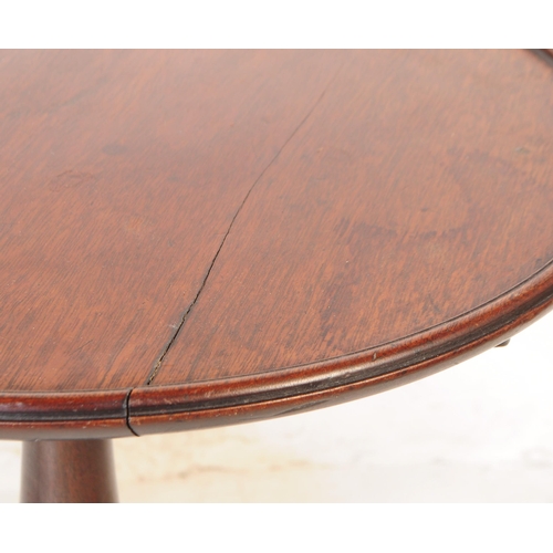 1107 - A pair of 19th century George III mahogany and oak pedestal wine tables. Each having circular tops o... 