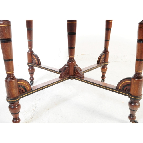 1111 - A 19th century Victorian Aesthetic era mahogany and ebonised wood octagonal centrepiece table. The t... 