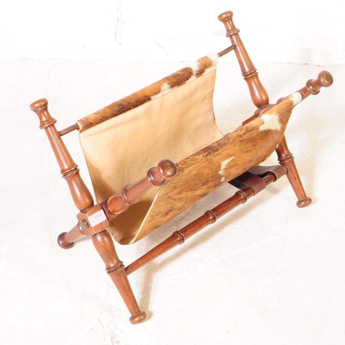 1114 - A mid 20th century mahogany frame magazine rack. The magazine rack having turned wood supports with ... 