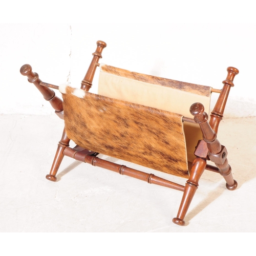 1114 - A mid 20th century mahogany frame magazine rack. The magazine rack having turned wood supports with ... 