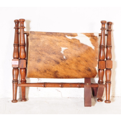 1114 - A mid 20th century mahogany frame magazine rack. The magazine rack having turned wood supports with ... 