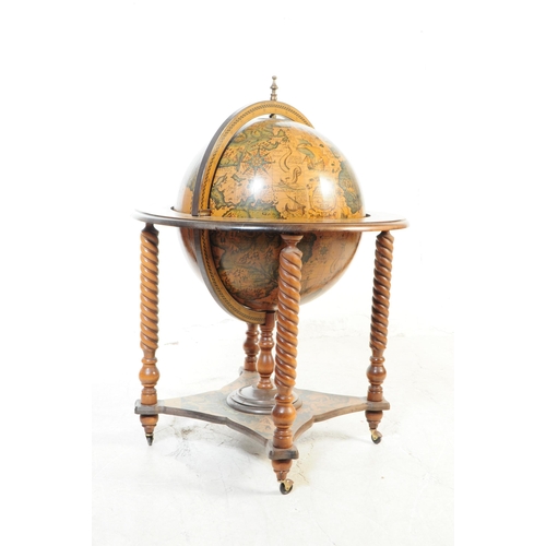 1118 - A 20th Century vintage mahogany veneer zodiac globe cocktail drinks cabinet / trolley. Having a hing... 