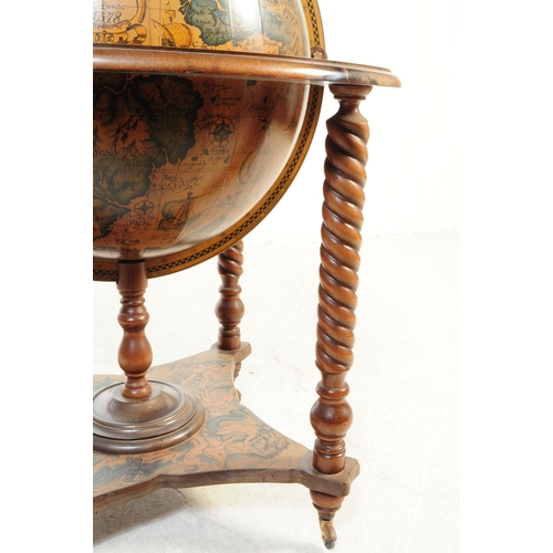 1118 - A 20th Century vintage mahogany veneer zodiac globe cocktail drinks cabinet / trolley. Having a hing... 