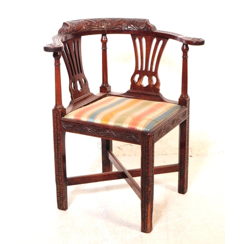 1120 - A 19th century George III carved mahogany corner armchair. The chair raised on carved block legs, ha... 