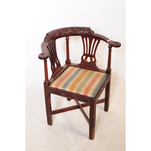 1120 - A 19th century George III carved mahogany corner armchair. The chair raised on carved block legs, ha... 