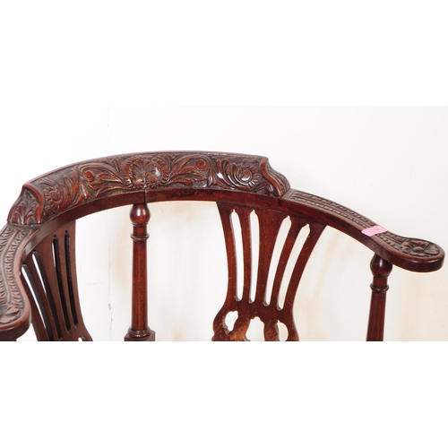 1120 - A 19th century George III carved mahogany corner armchair. The chair raised on carved block legs, ha... 