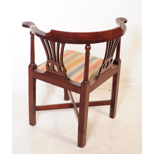 1120 - A 19th century George III carved mahogany corner armchair. The chair raised on carved block legs, ha... 