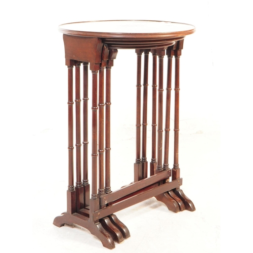 1121 - An Edwardian century mahogany inlaid nest of side tables. The nest of tables each featuring a rounde... 