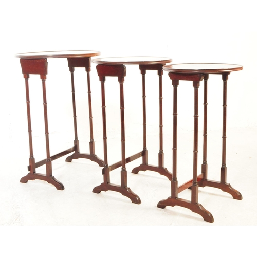 1121 - An Edwardian century mahogany inlaid nest of side tables. The nest of tables each featuring a rounde... 