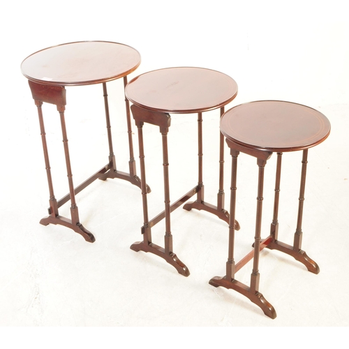 1121 - An Edwardian century mahogany inlaid nest of side tables. The nest of tables each featuring a rounde... 