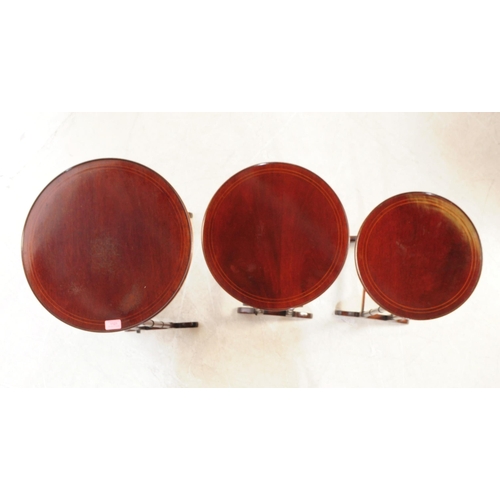 1121 - An Edwardian century mahogany inlaid nest of side tables. The nest of tables each featuring a rounde... 