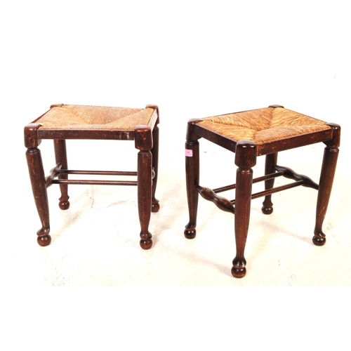 1122 - A pair of early 20th century oak wood rush seat stools. The stools raised on tapered rounded legs ov... 