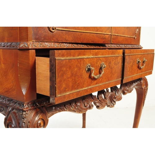 1125 - A 20th century walnut cocktail cabinet. The cabinet raised on carved cabriole legs, having a pair of... 