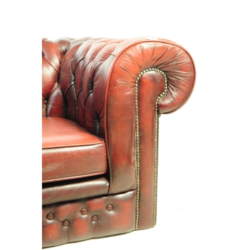 1126 - A 20th century Chesterfield two seater sofa settee. The sofa in oxblood red leather, featuring a but... 