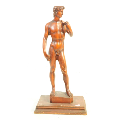 1130 - A large 20th Century carved wood David by Michelangelo sculpture / figure upon stepped square base. ... 