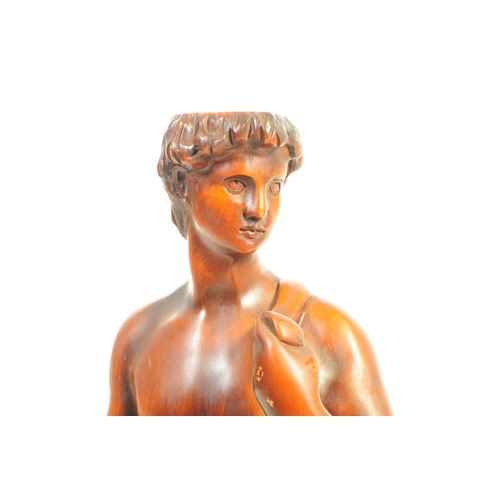 1130 - A large 20th Century carved wood David by Michelangelo sculpture / figure upon stepped square base. ... 