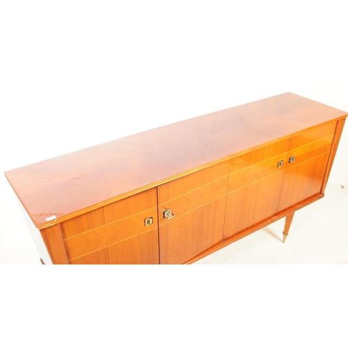 557 - A large mid century sideboard credenza in square form with tapering sides. Of solid wood constructio... 